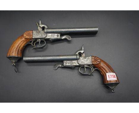 A pair of reproduction double barrel pistols.IN HOUSE SHIPPING IS NOT AVAILABLE ON THIS ITEM. 