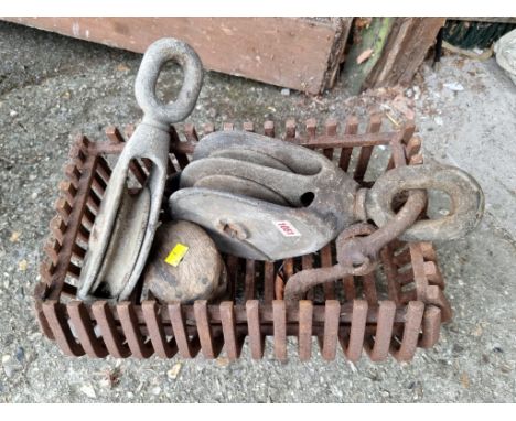 Three old winch blocks;&nbsp;together with a small cast iron fire grate.&nbsp; 