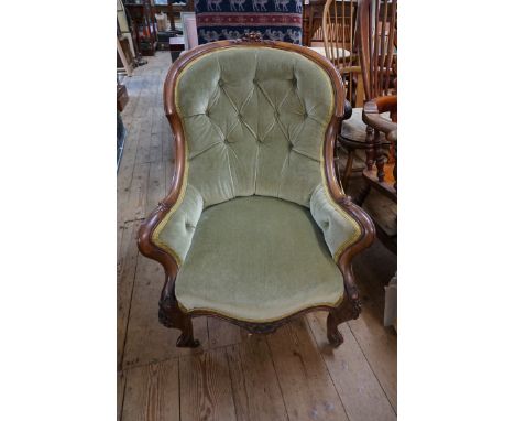 A Victorian carved walnut and button upholstered occasional armchair.&nbsp; 
