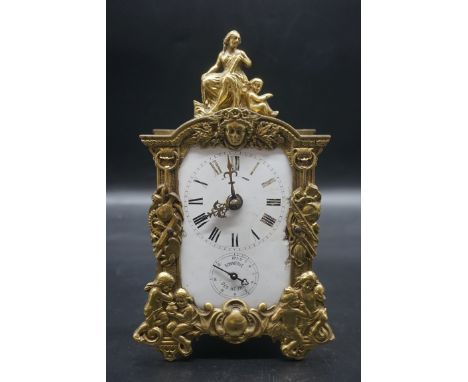 An antique French cast brass mantel clock,&nbsp;with enamel dial, 24cm high. 