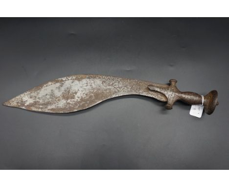 An 18/19th century Indo Nepalese tulwar hilted kukri, the 40cm blade engraved with a figure in a temple and foliage, no scabb