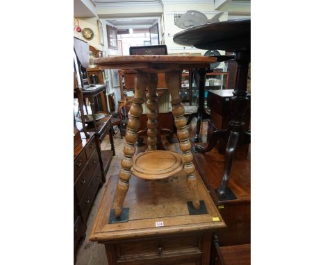 A 19th century pine cricket table,&nbsp;with bobbin turned legs, 44.5cm diameter.&nbsp; 