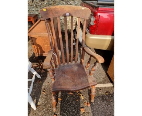 An antique comb back kitchen chair. 