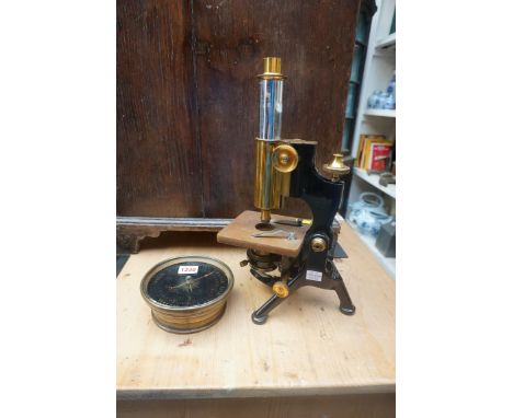 A brass and black painted monocular microscope, by Watson &amp; Sons, lacking eye piece; together with an aneroid&nbsp;barome