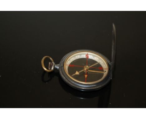 AN ANTIQUE COMPASS, GUN METAL GREY CASE