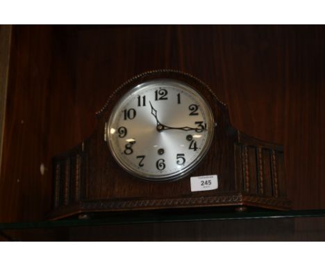 A VINTAGE CARVED OAK MANTLE CLOCK 