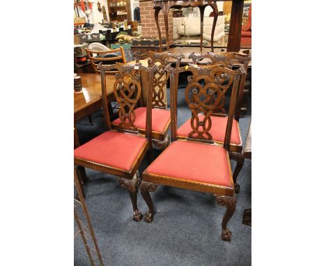 A SET OF FOUR CARVED MAHOGANY CHIPPENDALE STYLE DINING CHAIRS