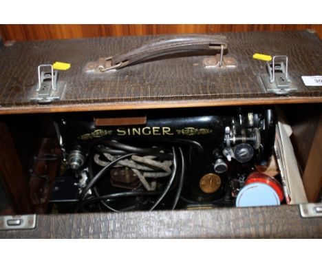 A CASED VINTAGE SEWING MACHINE 