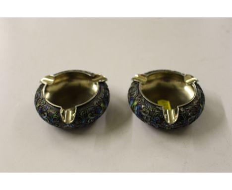 A pair of Chinese white metal enamel decorated ashtrays