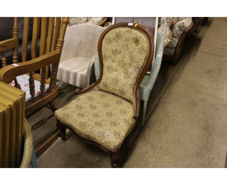 A Victorian walnut button back nursing chair