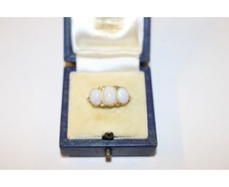 A yellow metal opal and diamond set ring