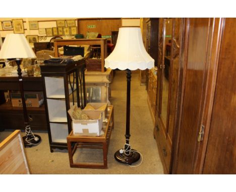 A mahogany standard lamp and shade