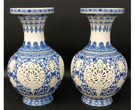 Pair of Chinese reticulated blue &amp; white porcelain baluster vases with cylindrical inserts, 29cm tall, printed blue faux 