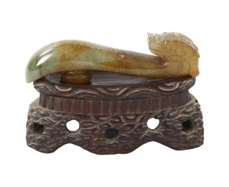 A Chinese carved jade dragon design buckle on hardwood stand, length 8cmGood condition 