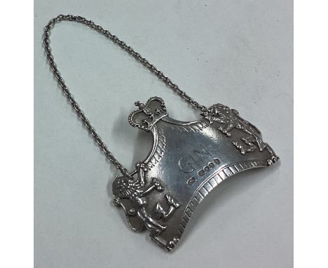 A silver decanter label for 'Gin' embossed with lion and crown decoration. By Leslie Gordon Durbin. Approx. 34 grams. Est. £1