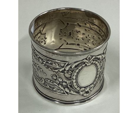 A silver napkin ring with embossed decoration. Circa 1880. By Carl Fabergé. Approx. 37 grams. Est. £200 - £300.