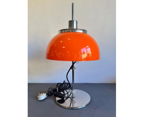 A retro 1970s orange acrylic and chrome table lamp - with domed shade and plain column to a circular base, 60 cm high.