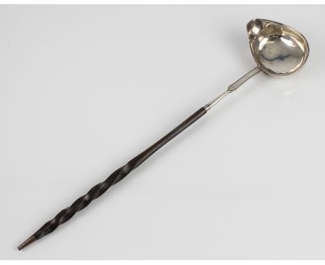 A 19th century white-metal toddy ladle - no marks, the oval bowl with side spout and engraved monogram, the stem with bifurca