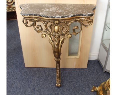 An antique carved gilt, gesso and marble console table - the later grey and white marble top on a foliate giltwood base with 