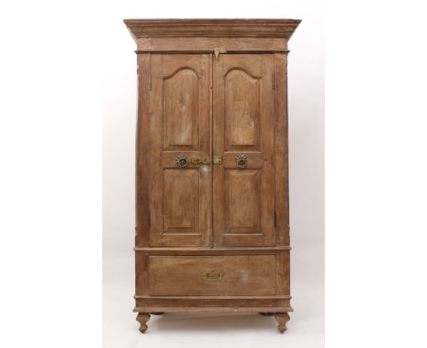 An Indian panelled hardwood cupboard - mid-20th century, probably teak, the flared, moulded cornice over two panel doors with