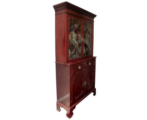 A good George III mahogany cupboard bookcase of small proportions - the carved dentil cornice over a pair of boxwood-strung, 