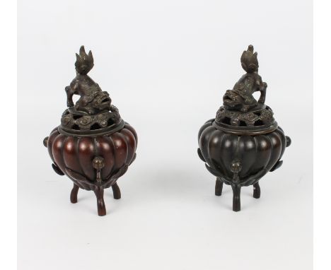 A pair of Chinese bronze tripod censers - probably early 20th century, of pumpkin or gourd form, with three naturalistic bran
