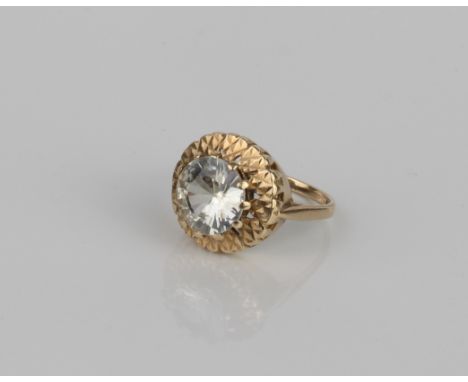 A vintage 9ct gold ring set with a large white stone - hallmarked London 1967, the claw set 9.75 mm stone over a bright cut b
