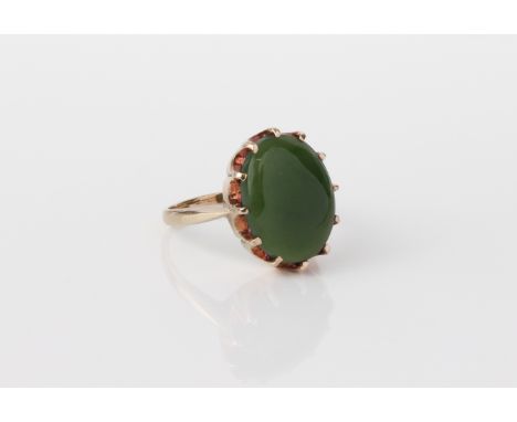 A vintage 9ct yellow gold and jade ring - the 14 x 11mm oval cabochon green jade in a crown claw setting, size N.
