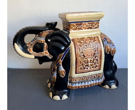 Three large pieces of Oriental pottery and porcelain - modern, comprising an earthenware elephant seat with black, buff, tan,