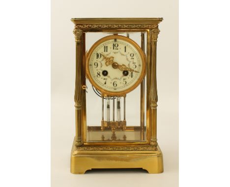 A late 19th century brass four glass mantel clock - the circular porcelain dial with Arabic numerals and floral swags, fronti