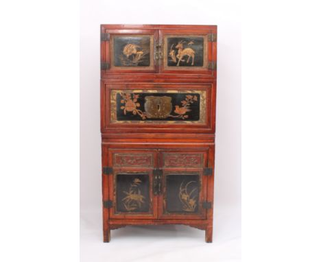 A Chinese red stained pine, lacquered and parcel-gilt three-piece compound cabinet - probably early 20th century, the two-doo