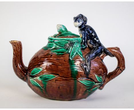 Majolica Teapot 1820 Majolica teapot with a monkey astride a cocnut with its tail coiled around the twig handle, with leaf de