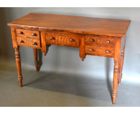 A 19th Century Mahogany Side Table with three drawers and a cupboard door raised upon ring turned legs, 122cms x 51cms, 79cms