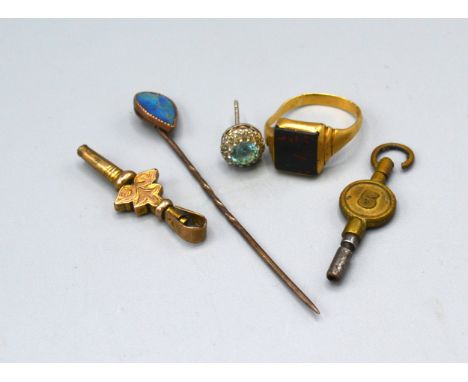 A yellow metal signet ring set stone together with a stick pin, an earstud and two watch keys 