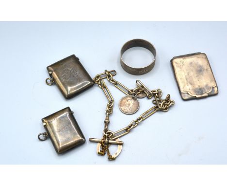 A Sheffield Silver Vesta Case together with a Birmingham silver vesta case, a Birmingham silver card case, a silver napkin ri