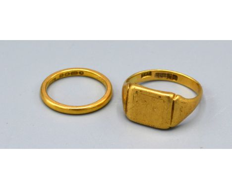 A 22ct gold wedding band 3gms together with a 18ct gold signet ring 7.6gms 