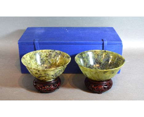 A Pair Of Chinese Jade Bowls upon hardwood stands 13.5cms diameter within fitted lined box 