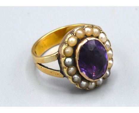 An 18ct. Gold Amethyst And Pearl Set Ring with a central amethyst surrounded by pearls, 7.4gms. ring size N 