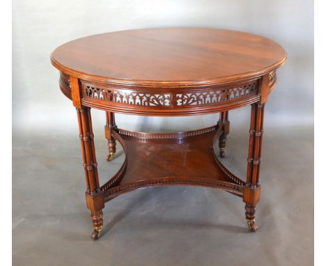 A Walnut Circular Centre Table, the moulded top above a pierced frieze and raised upon four quadruple ring turned column supp