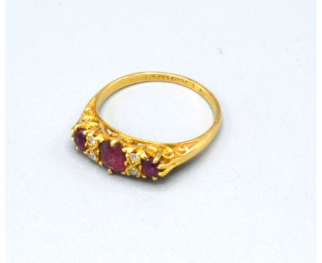 An 18ct. Gold Ruby and Diamond Ring set with three rubies interspaced with four diamonds, 3.4 gms ring size M 