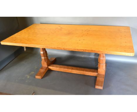 Robert (Mouseman) Thompson, An Oak Refectory Dining Table, the adze carved top above twin end octagonal supports with stretch