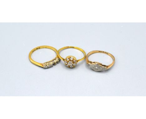 An 18ct. Gold Cluster Ring together with another 18ct. gold ring and a 9ct. gold dress ring 