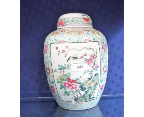 A CHINESE FAMILLE ROSE OVER FORM JAR AND COVER with polychrome bird and flower decoration within shaped black lined cartouche