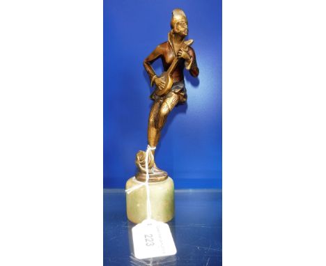 AN ART DECO STYLE GILT SPELTER FIGURE OF A GIRL playing the banjo, standing on an onyx base, 20cms high