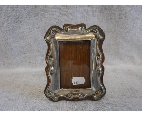 A SILVER EASEL PHOTOGRAPH FRAME with light oak back 5.5" high 