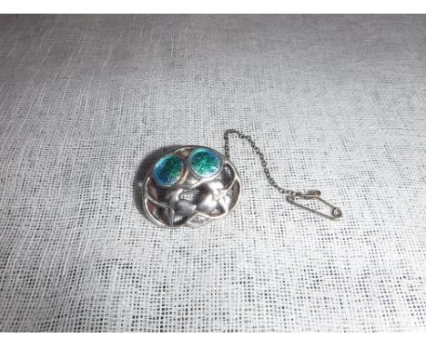 A SILVER AND ENAMEL BROOCH by Charles Horner, decorated with stylised leaves on a pierced ground