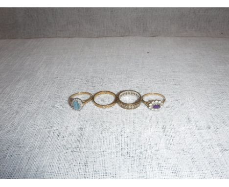 A 9CT YELLOW GOLD DIAMOND AND BLUE STONE CLUSTER RING and three other yellow gold and yellow metal dress rings (4)