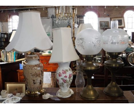 TWO VICTORIAN STYLE BRASS OIL LAMPS with glass shades and two table lamps with ceramic bases
