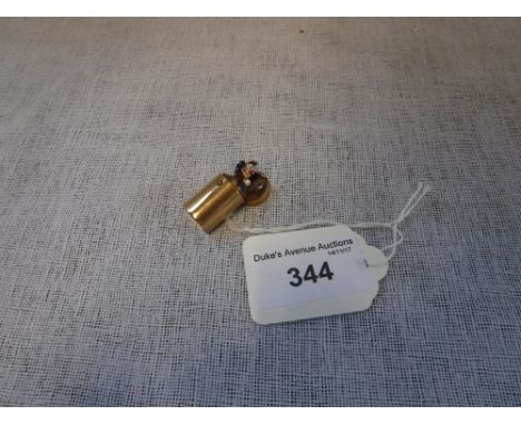 A GOLD PLATED AND ENAMEL CHARM in the form of 'Punch' in a cylindrical box, c.2.5cms high