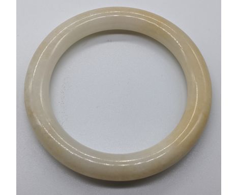 A Chinese white jade bangle, D.7.5cm